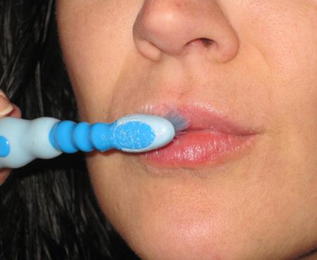 Exfoliate your lips with a gentle toothbrush to remove black spots